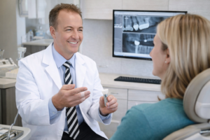dentist in woodbury mn explaining about dental implants